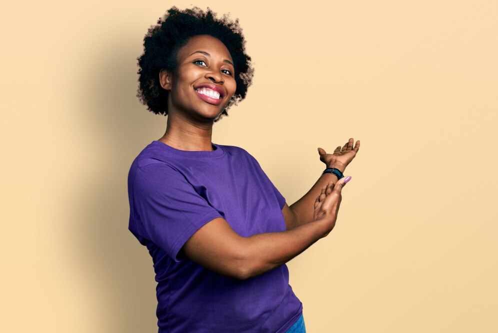 african-american-woman-with-afro-hair-wearing-casual-purple-t-shirt-inviting-enter-smiling-natural-with-open-hand_839833-9524